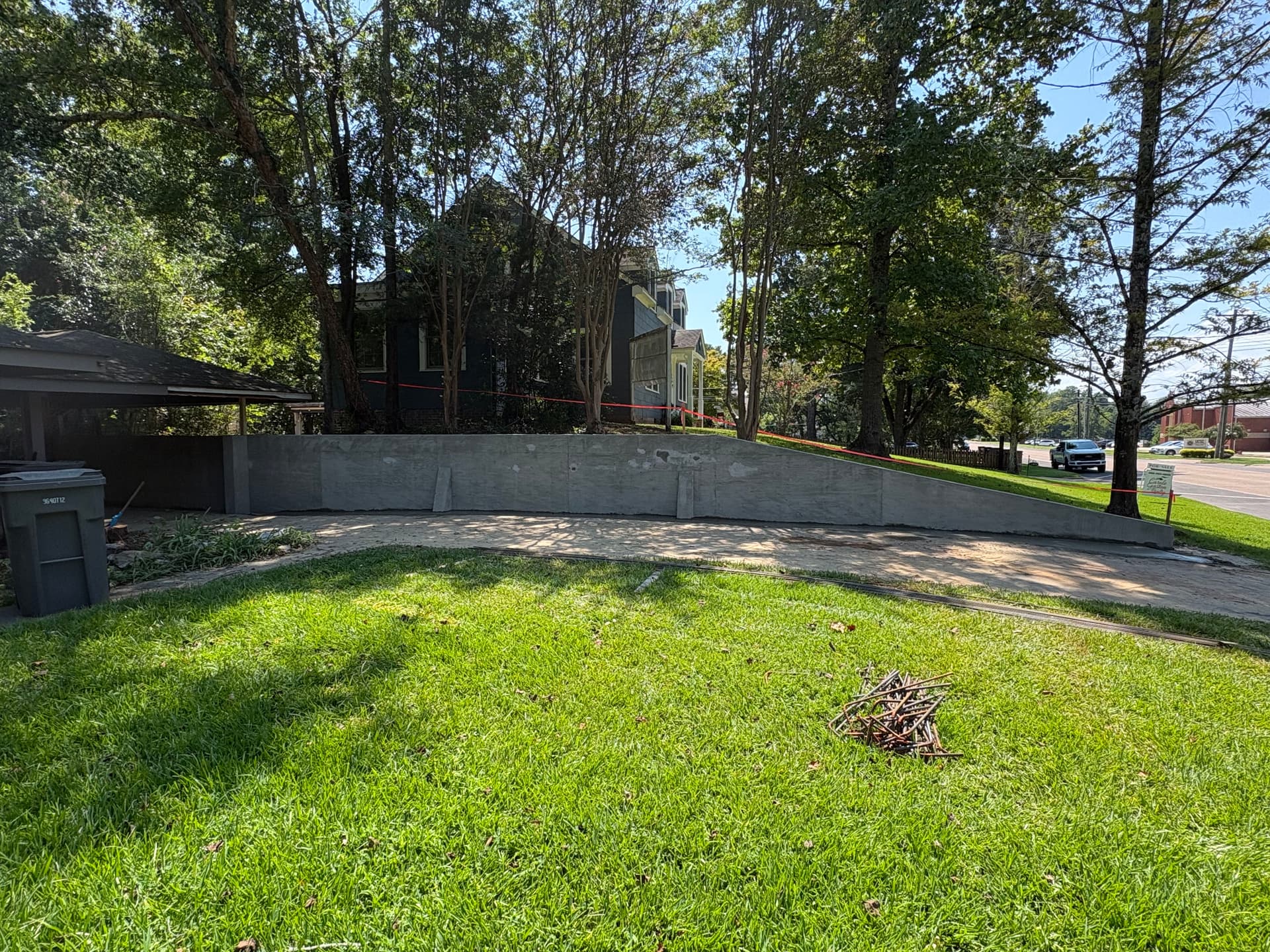 Gallery photos for Poured Concrete Retaining Wall Built to Hold Grade Along a Driveway: Image #1